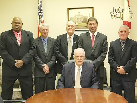 Commissioner Joe Acker (seated) assumed the chairmanship of the commission at the Nov. 14 meeting. Shown standing, from left are commissioners John Underwood, Billy Joe Rodgers, James Knight, Shane Hughes and Barry Corkren.