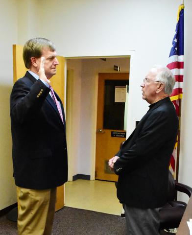 Probate Judge William Oswalt (right) is shown issuing the oath of office to Superintendent Jim Burkhalter prior to the Dec. 4 Fayette County Board of Education meeting. Burkhalter is beginning his second term as superintendent.