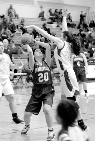 Madison Cribb (20) looks for an opening to shoot the ball.