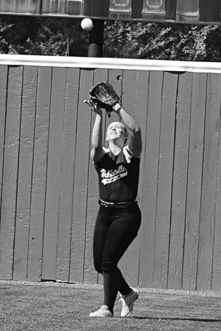 Gracie Dodd of Hubbertville catches a fly ball for an out.