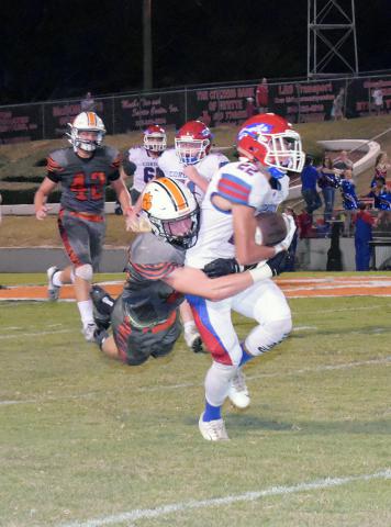 Parker Nichols (26) makes a leaping tackle of the Cordova runner.