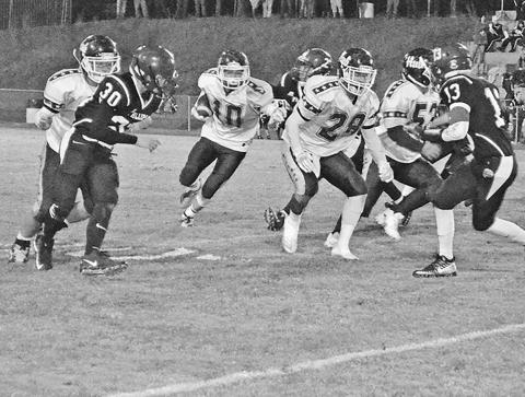 Gage Alexander (10) is shown running the ball for Hubbertville as Robert Anthony (28) and Cody Tidwell (53) block.