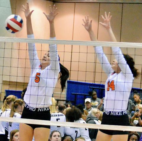 Shown are Karli Rushing (5) and Kayley Strickland (14) blocking a shot by a Danville player.