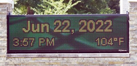 This thermometer, outside a local church, shows the temperature on the second day of summer as 104 degrees.