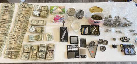 Pictured is a large amount of cash, drugs and drug paraphernalia that was seized while serving a search warrant on July 6.