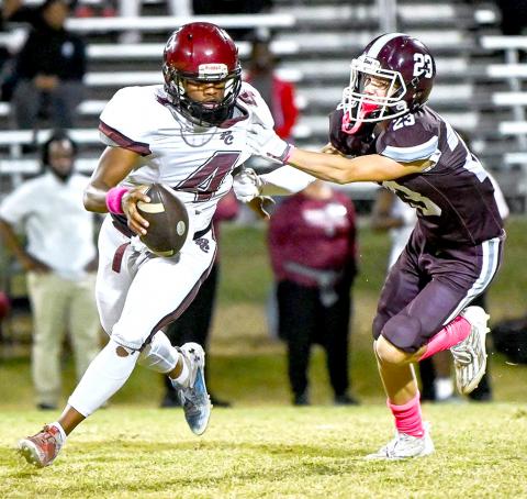 Kane Rushing (23) of Hubbertville is shown in pursuit of the Pickens County quarterback.