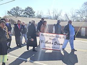 Marchers head toward First Baptist Church.