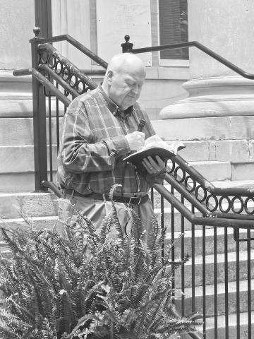 Dr. John Killian, Director of the Fayette County Baptist Association, reads from 1Timothy chapter two at the county courthouse May 7. 