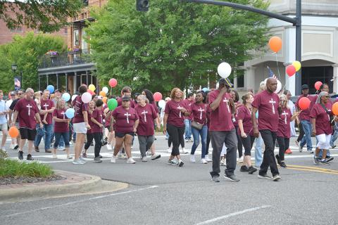 Marchers head north down Temple Ave. toward the courthouse where they will release their balloons and walk on to Fayette First Baptist Church.  