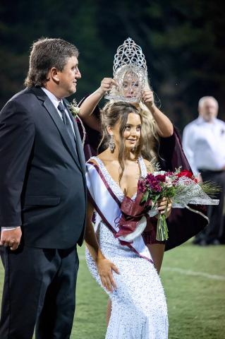 Addison Tucker was crowned Hubbertville High School’s 2026 Homecoming Queen during halftime festivities at the Lions’ homecoming game against Brilliant on Sept. 4. Tucker received the crown from 2025 Homecoming Queen Zoe Whitson as her escort, Heath Tucker, looked on. 
