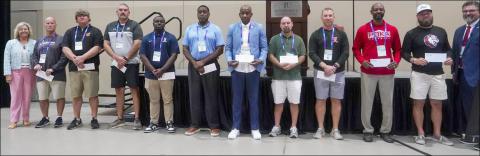 AHSAA incoming Executive Director Heath Harmon (far right) and Associate Executive Director Kim Vickers (left) congratulate the 10 schools receiving a $1,000 Sportsmanship Grant from Friday. Representing the schools were, from left: Danny Raines, Berry HS; Zac Welch, Alexandria HS; Adam Fossett, B.B. Comer HS; Eric Hines, Paul Bryant HS; Edwin Burke, Murphy HS; Luther Riley, Greensboro HS; David Offerle, St. Michael Catholic HS; David Watts, G.W. Long HS; Albert Weeden, Loachapoka HS; and Josh Wallace, Sard