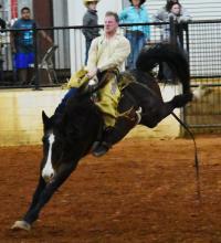  This bronco rider is shown completing a successful ride at the 13th annual Cattlemen’s Association PCA Rodeo In Fayette.