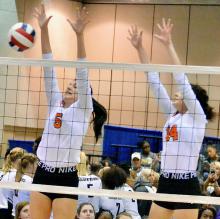 Shown are Karli Rushing (5) and Kayley Strickland (14) blocking a shot by a Danville player.