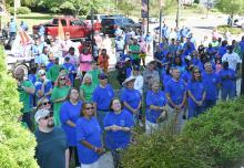 Participants in the “March for Jesus” are shown listening to speakers in front of the First Baptist Church.