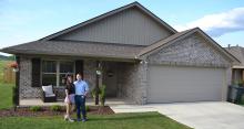 Matt and Sidney Cunnings are pictured in front of their brand new garden home.