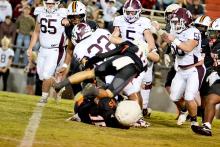 Fayette County’s Andrew Lollar (15) and Michael Tyree (16) team up for a tackle on an Aggies’ ball carrier.