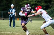 Hubbertville’s Cruz Kizzire stiff arms a Pickens County defender. The junior finished with 4 receptions for 79 yards and a touchdown.